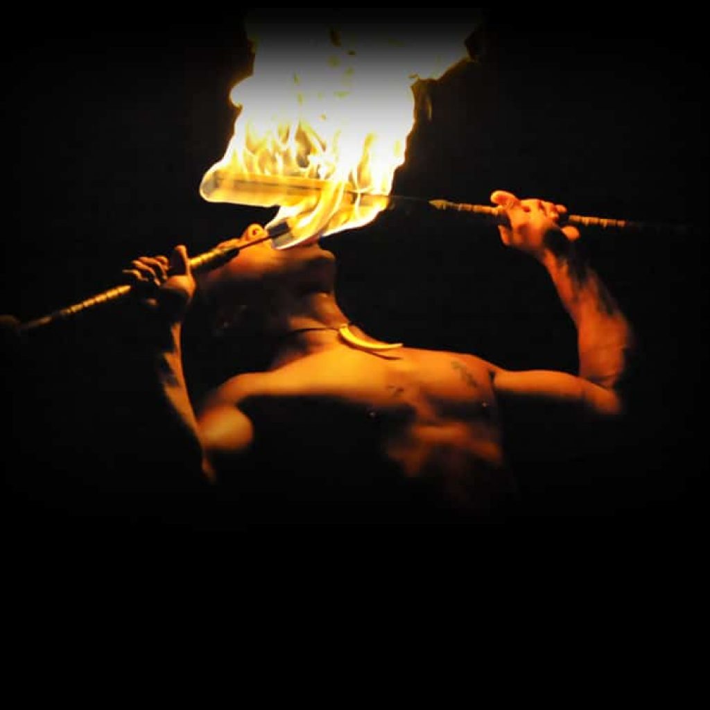 man eating fire at luau kalamaku luau ceremony