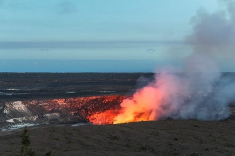 red light and steam emits from active volcano