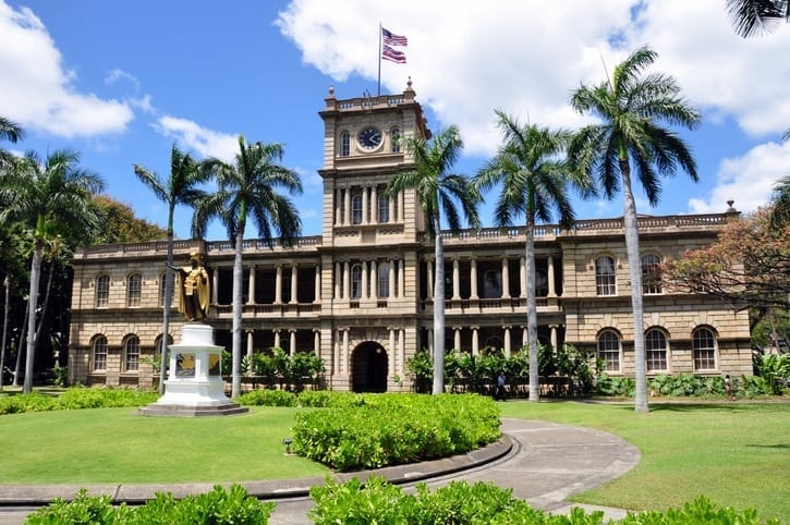 king kamehameha statue standing in front of iolani palace in honolulu