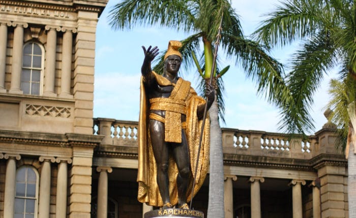 gold robed king kamehameha statue in front of iolani palace in honolulu