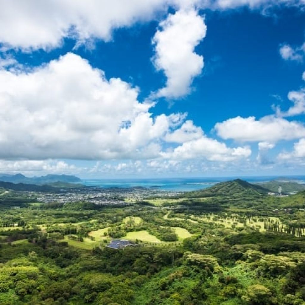 nu'uanu pali lookout - clouds above a deep green valley surrounded by ocean on all sides