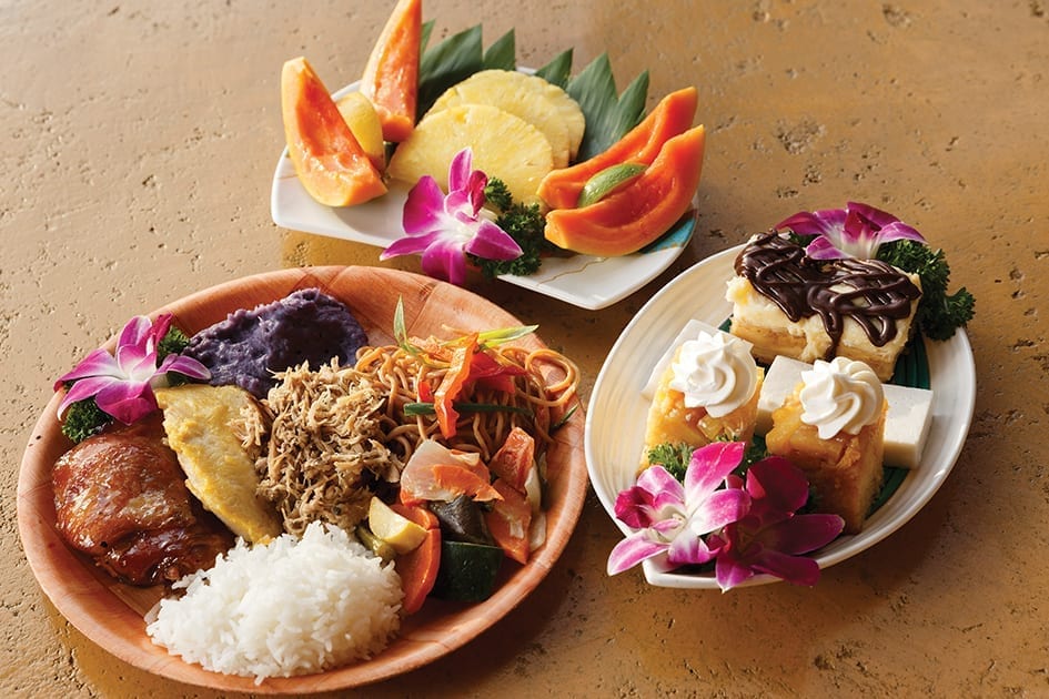 3 plates filled with hawaiian delicacies - fruit rice chicken noodles pineapple cake